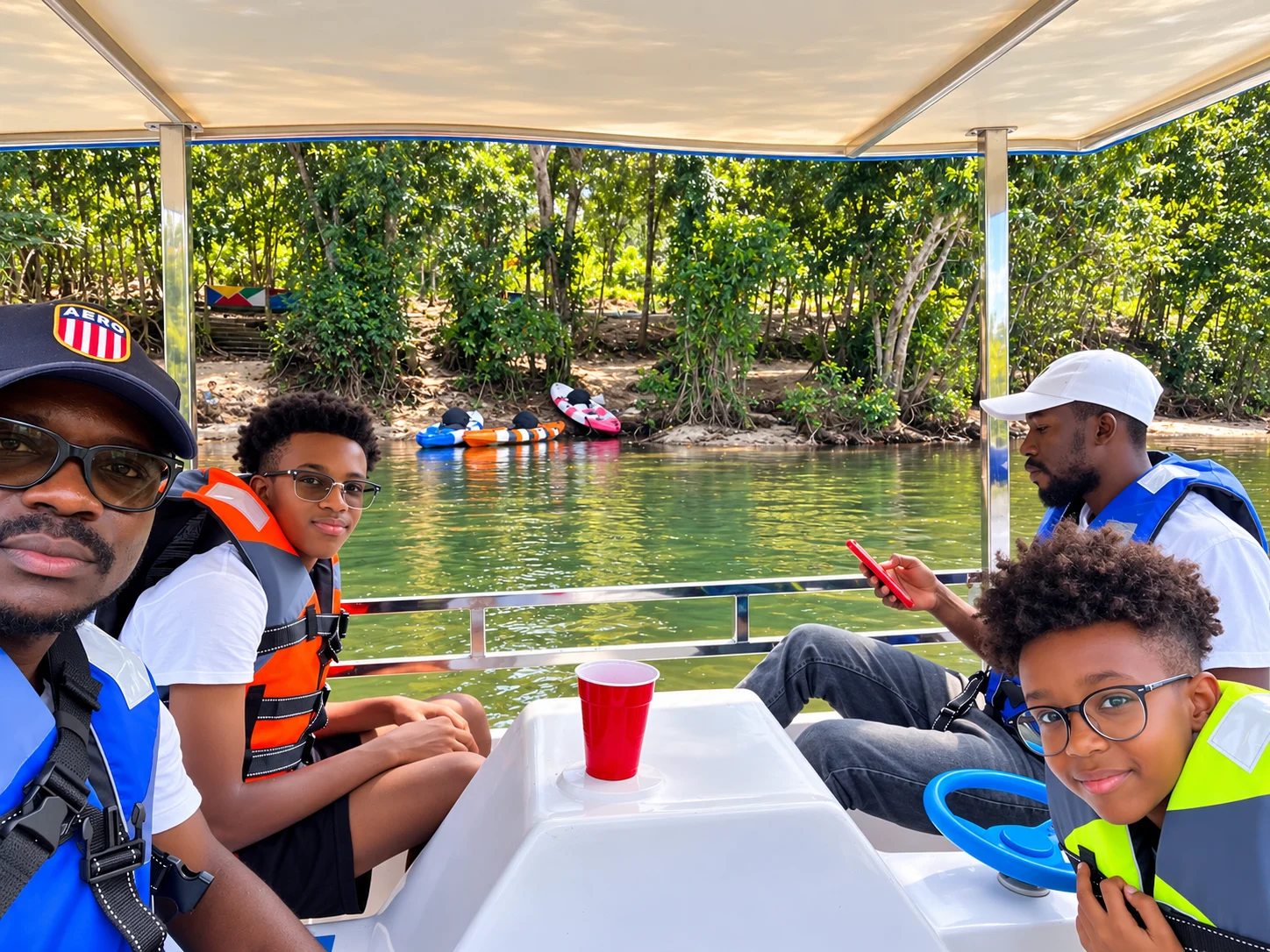 Visitors wearing life jackets together on a shaded boat at Bush Garden