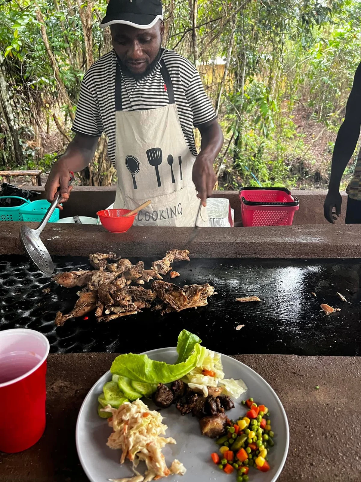 Food being prepared beside a serving area