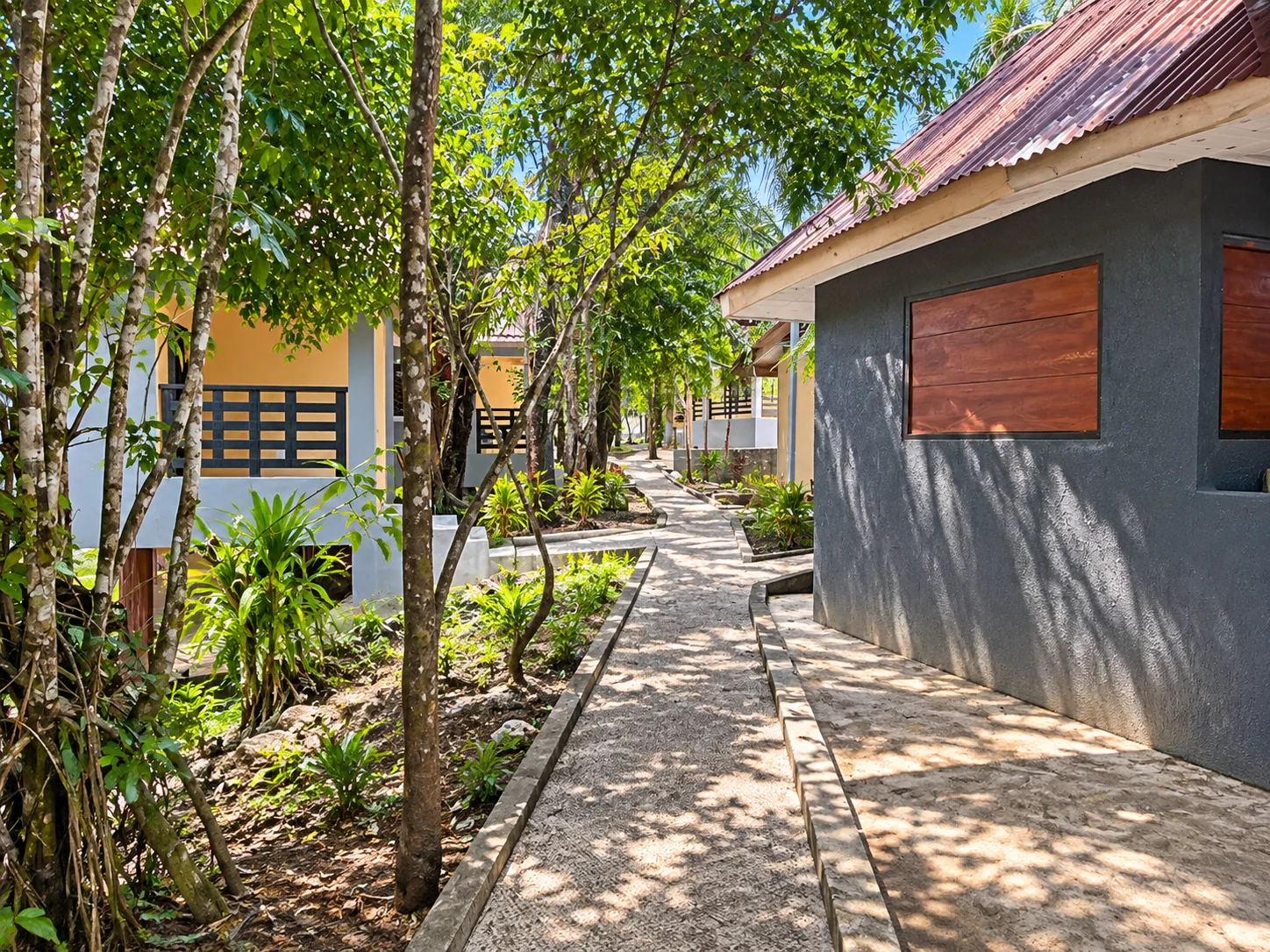 A shaded path between garden rooms